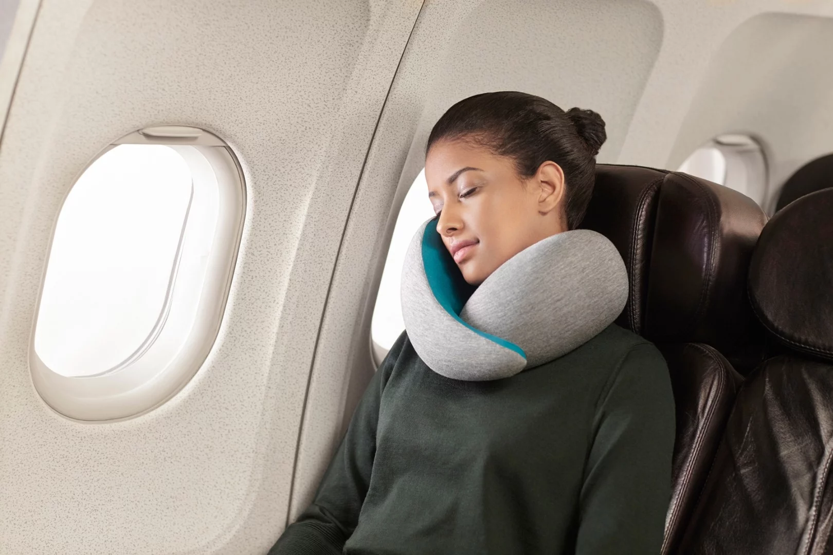 The Ostrich Pillow Go is a travel pillow that is fitted around the user's neck