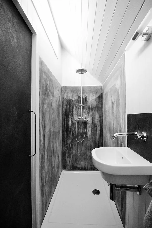 Inside, the cabin features a very plush looking modern bathroom with patterned zinc shower cubicle, toilet, and sink