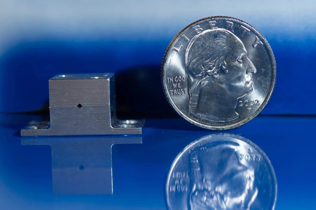 The new quantum cascade laser, which could help astronauts hunt for water on the Moon, next to a US quarter for scale