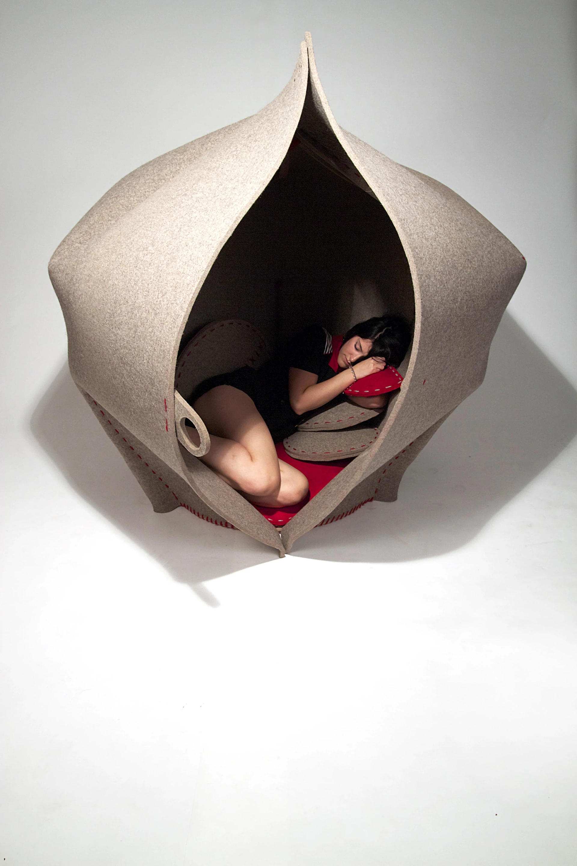 A number of cushions are attached, which form a nest-like floor when HUSH is in its seed case-like tent mode, and the seat of the chair when turned inside-out into the baseball mitt-resembling chair