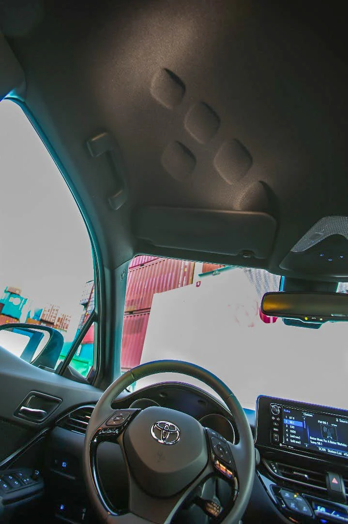 Odd indents in the headliner above both the driver and front passenger are an homage to the Toyota C-HR's "Distinctive Diamond" design origins