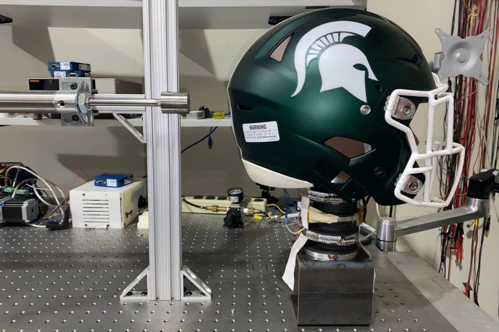 In this variation on the testing setup, the "bandage" sensors can be seen adhered to the neck beneath the helmet
