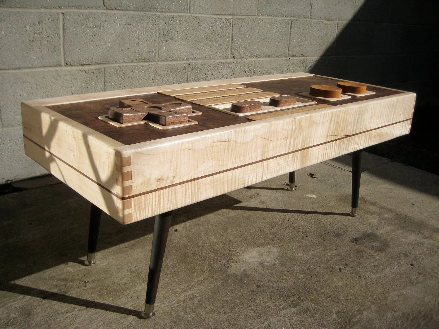 Rather than reproduce the black, gray and red coloring plastic original, Lushear has instead opted for the natural tones of maple, mahogany and walnut