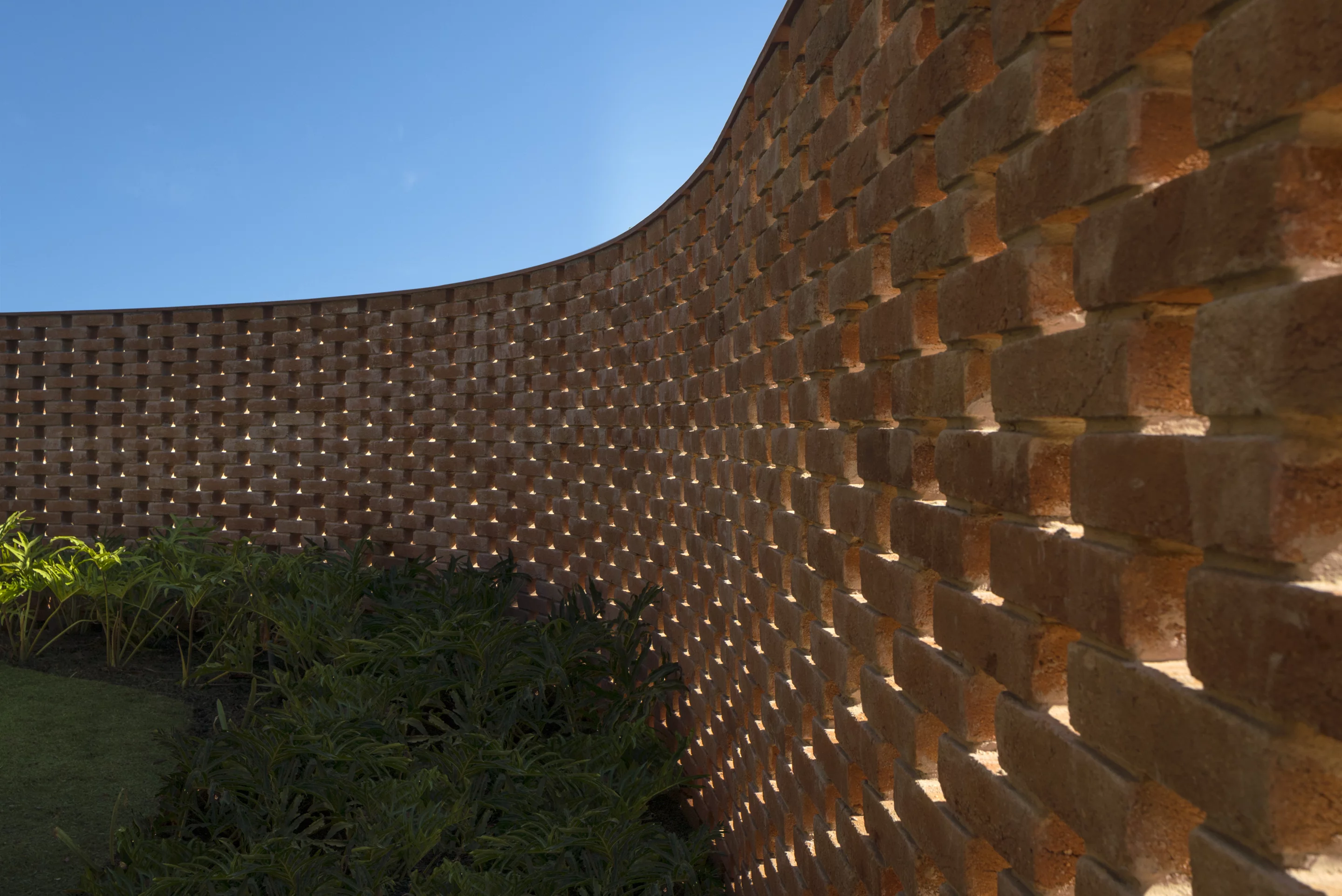 Closeup shot of Planar House's large curving brick wall