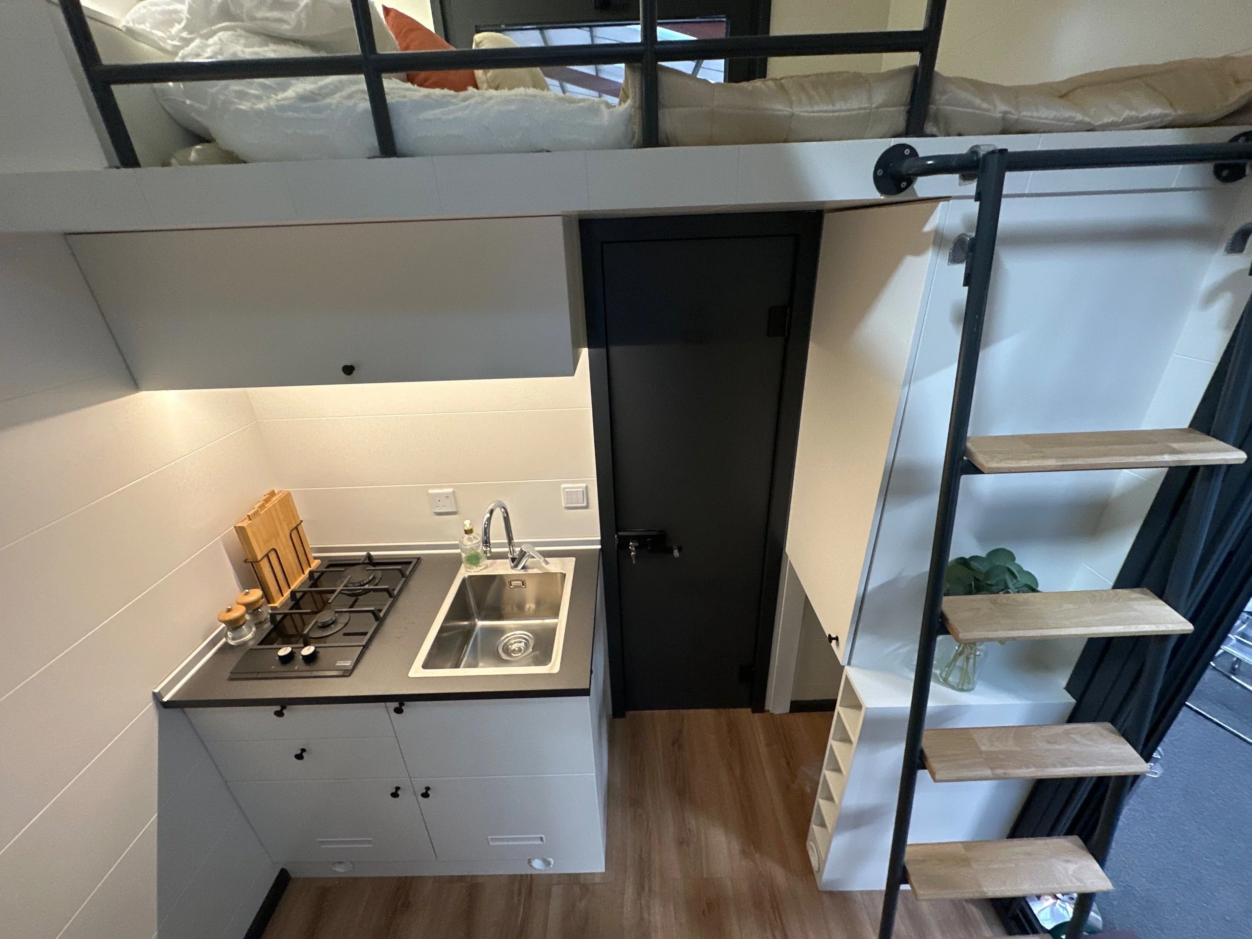 The Mo.5 450's kitchen is very simple and includes a two-burner propane-powered stove, a sink, cabinetry, and space for a fridge