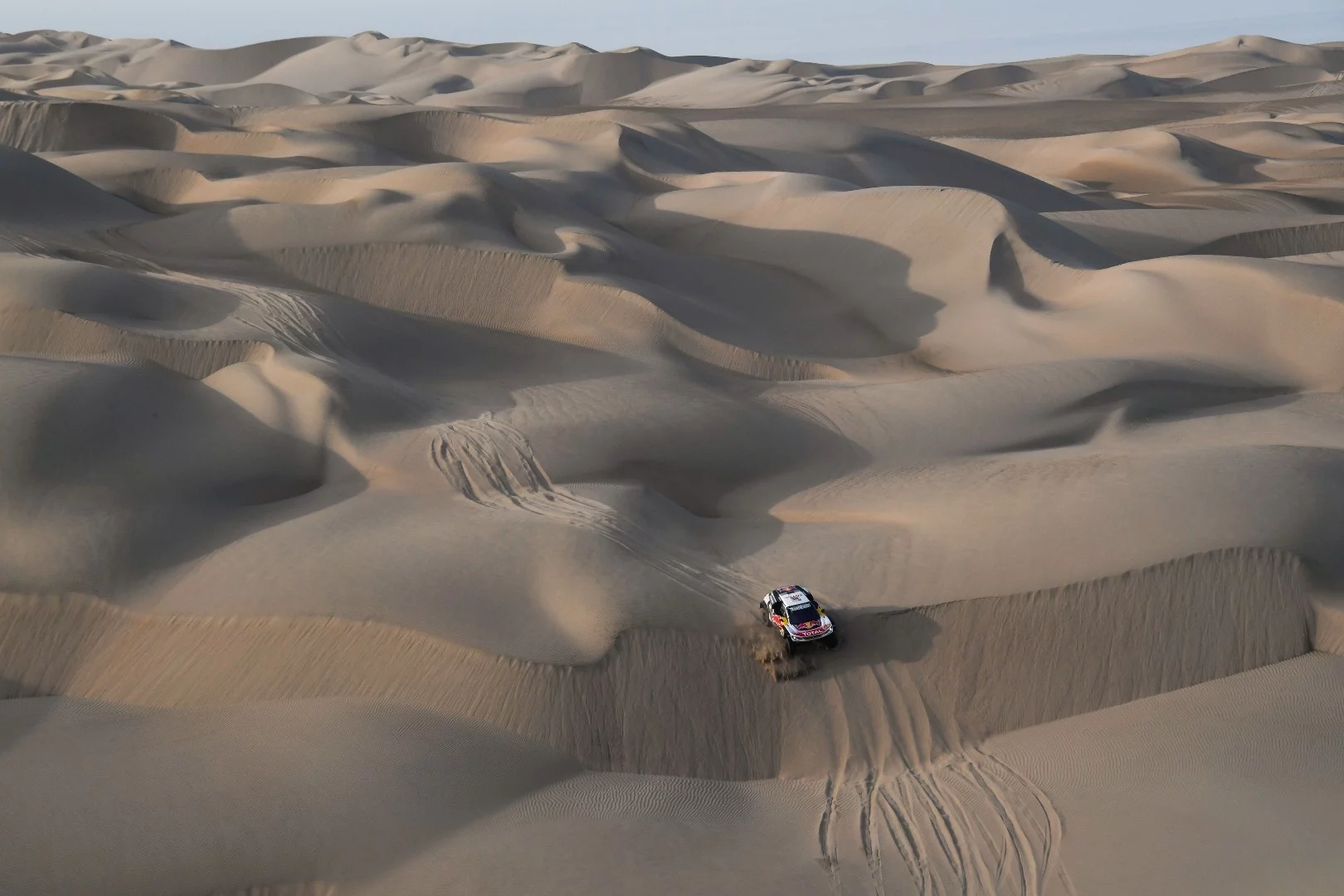 The terrain is unrelenting for Loeb and Elena as they push their Peugeot through Stage 5
