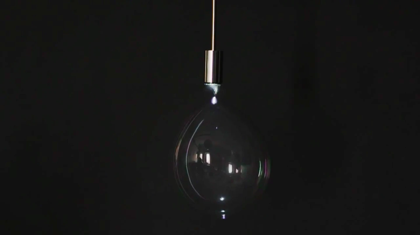 Instead of a lampshade, the Surface Tension Lamp continuously blows bubbles