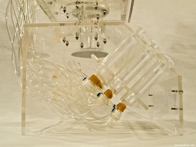Liquid flows from the cocktail typewriter's syringes when the keys are depressed