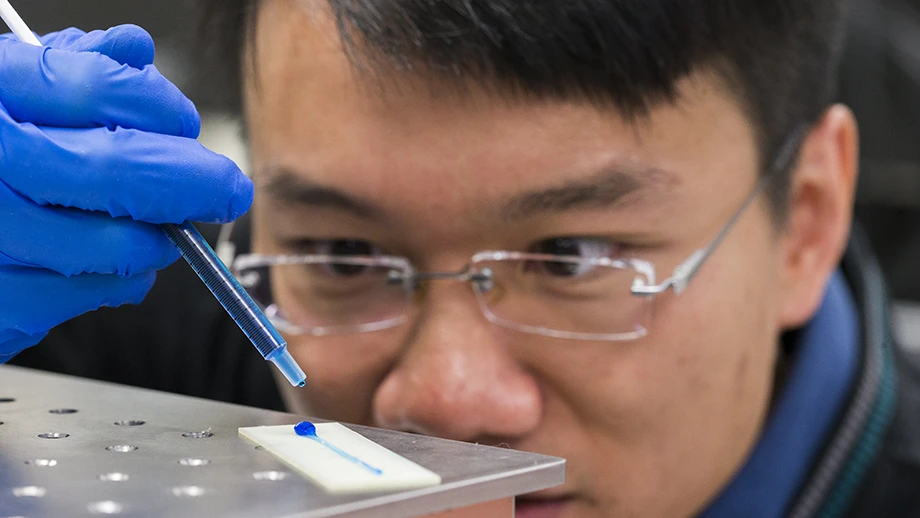 William Wong places a drop of water on the material