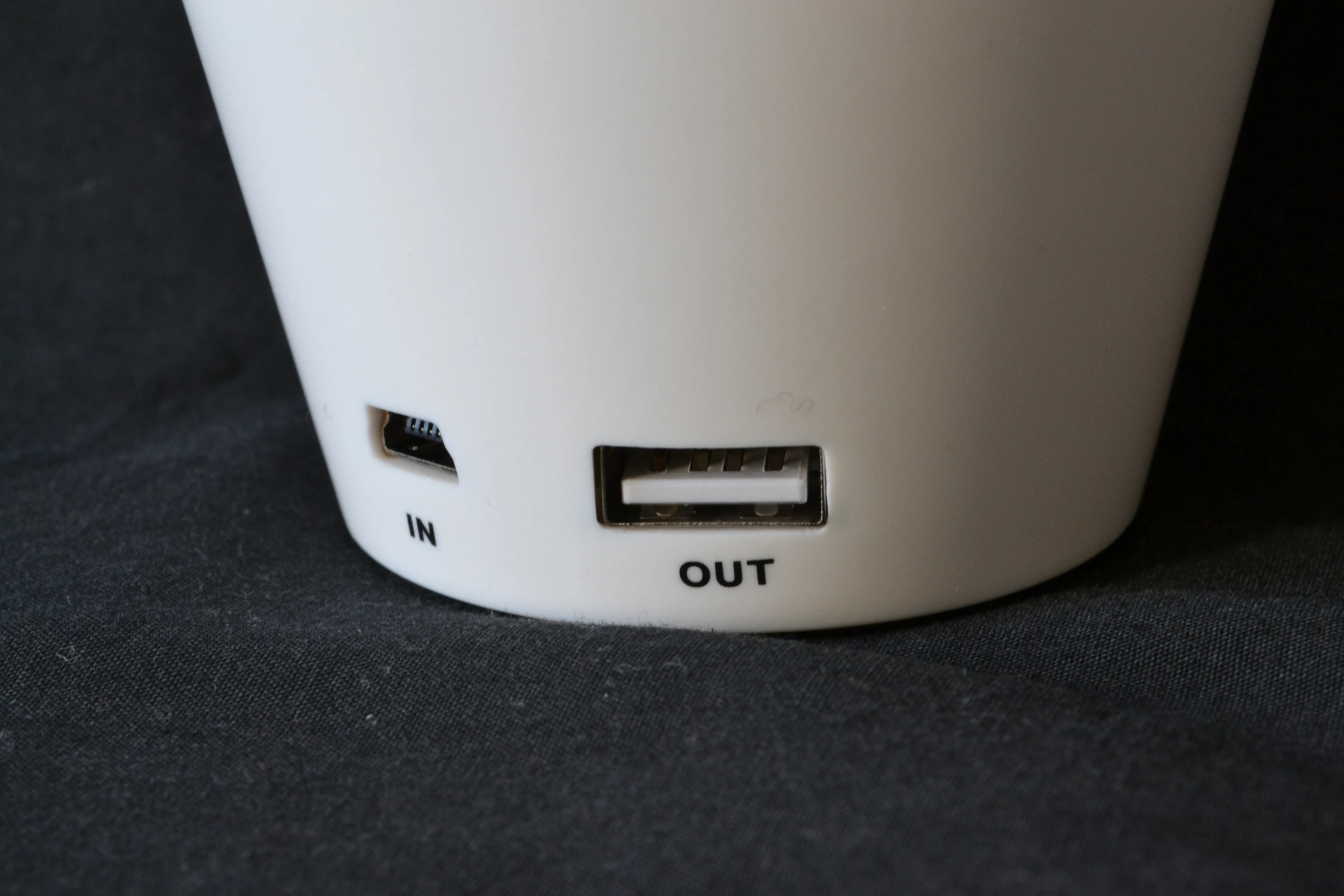 To the rear, a mini-USB input port and a full-size USB power-out port