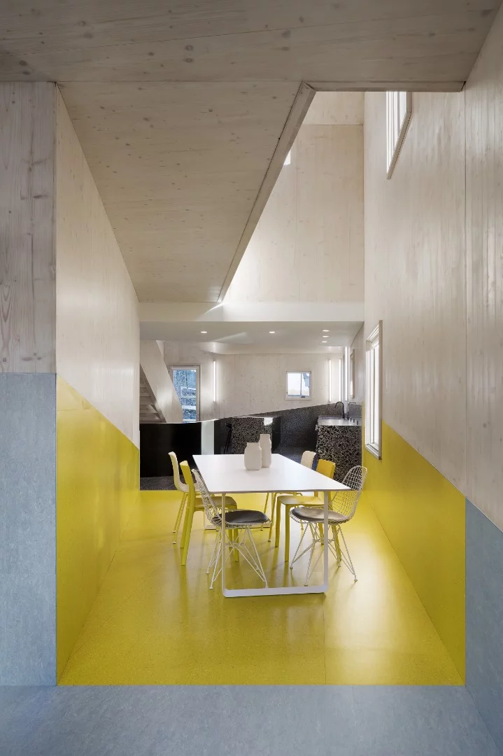 The interior design boasts a mix of classic and non-traditional materials, including bright colored vinyl flooring and side-walls