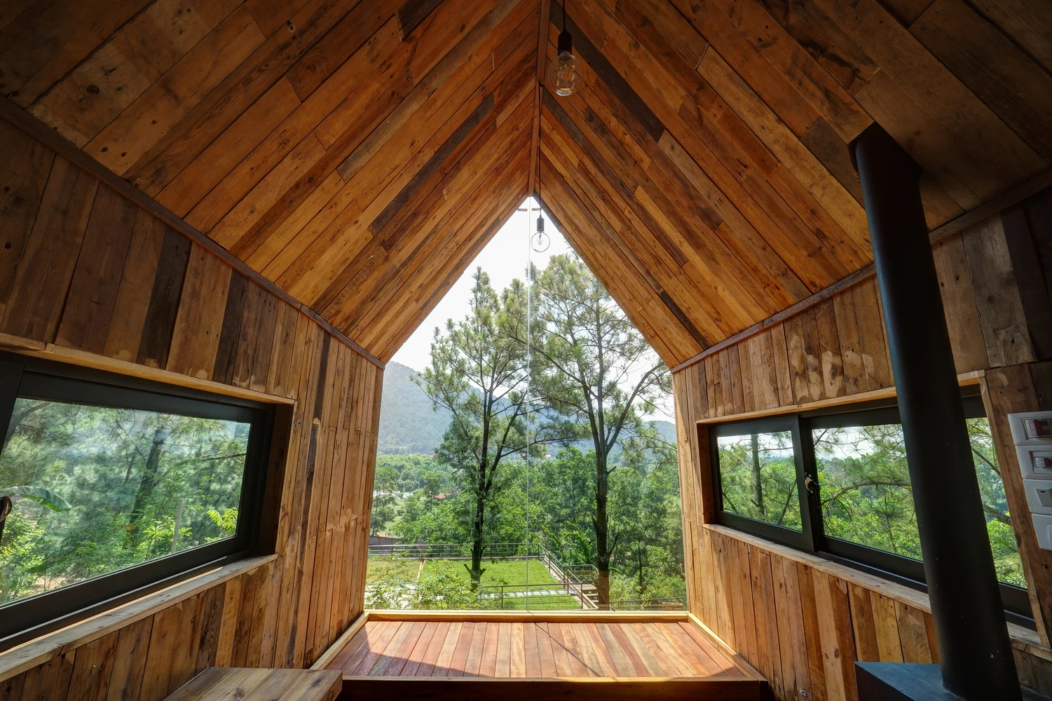 Constructed using local pine wood, the timber home is built into the side of aslope