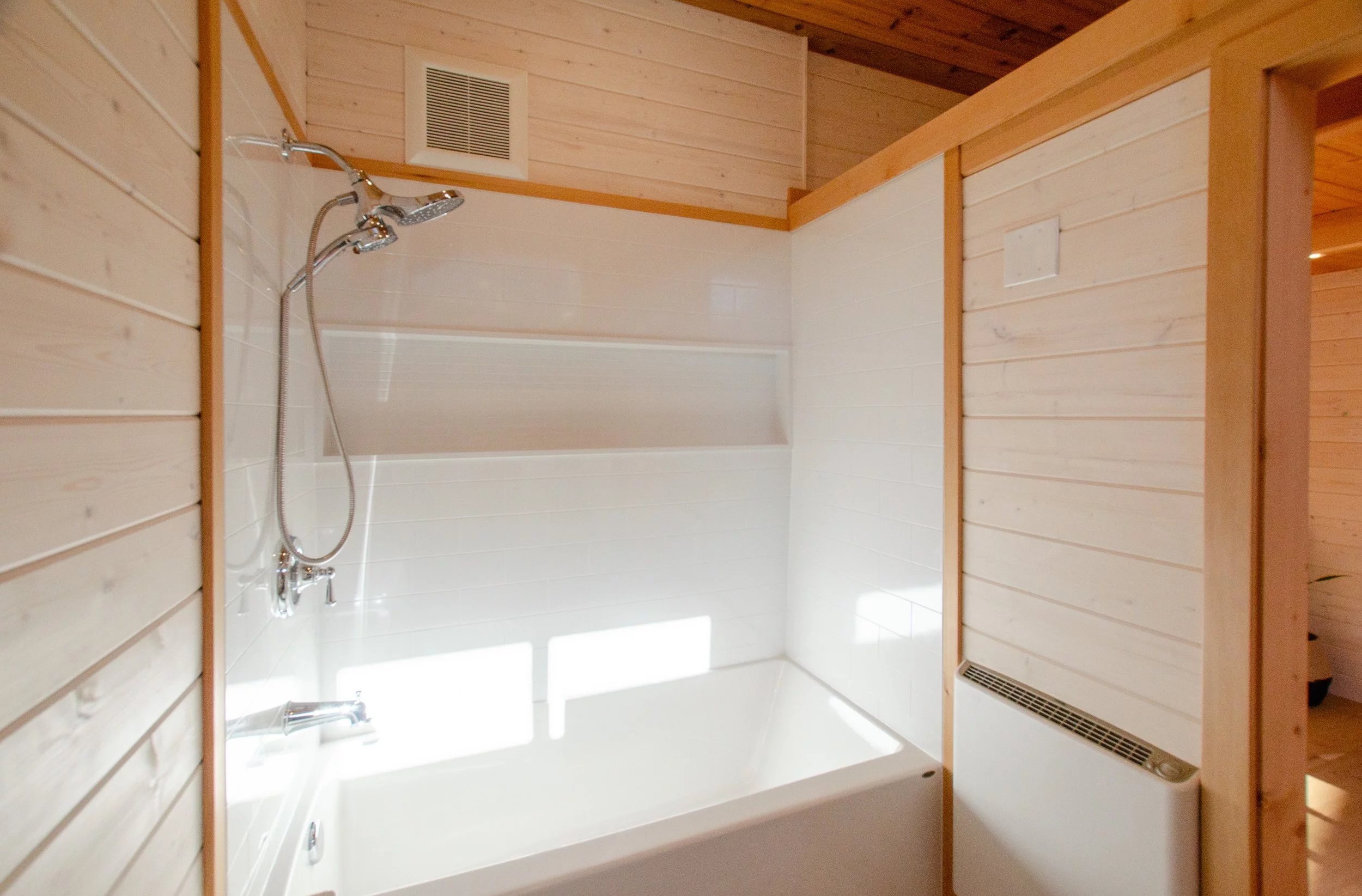 The Juniper's bathroom includes a bathtub/shower, which is a rare luxury in a tiny house