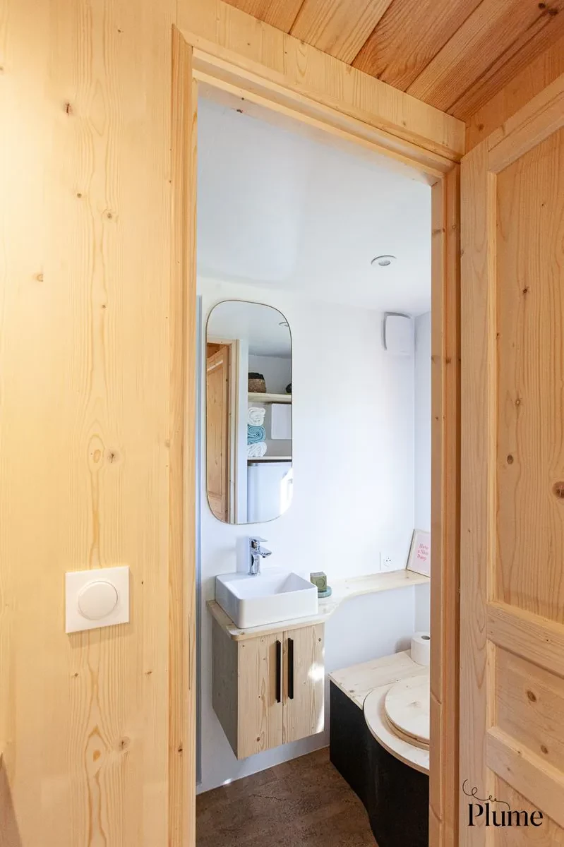 The Cosmos' bathroom is small but does include a shower, sink, and a toilet