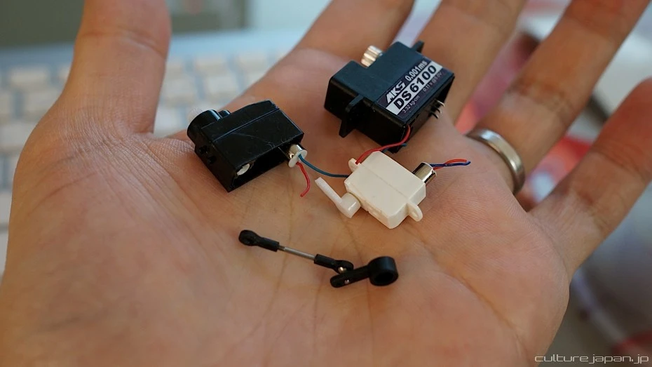 Delicate micro servos are stripped of their plastic casings in order to fit inside Smart Doll's thin limbs