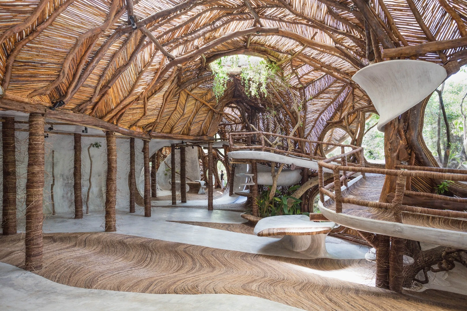 Designed to connect its visitors with nature, guests are invited to wander barefoot across the IK Lab's winding, polished cement floors