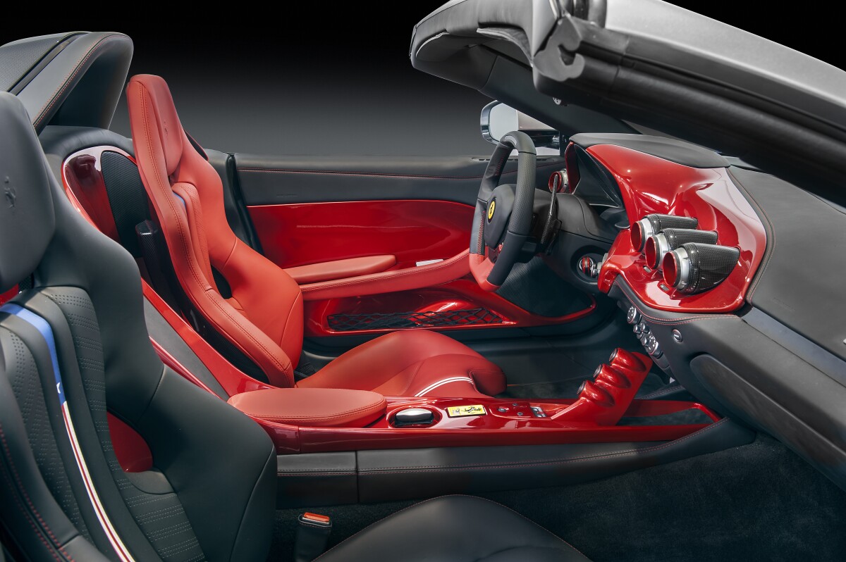 The F60's interior is trimmed in red on the driver's side, and black on the passenger side