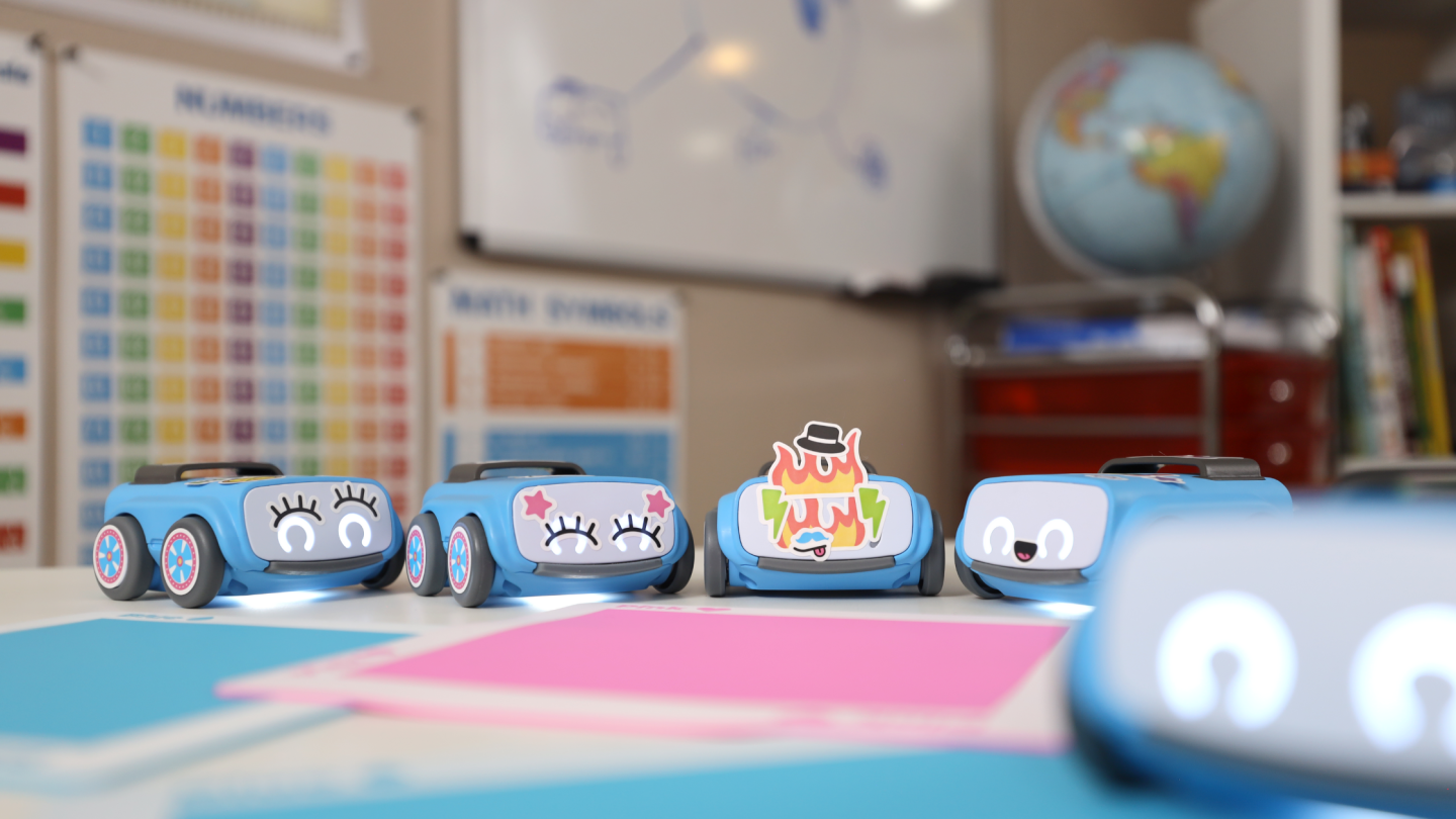 The learning kits come with an indi robot car, some tiles that serve as color-coded instructions for the bot, some challenges, and some stickers to customize the little bot