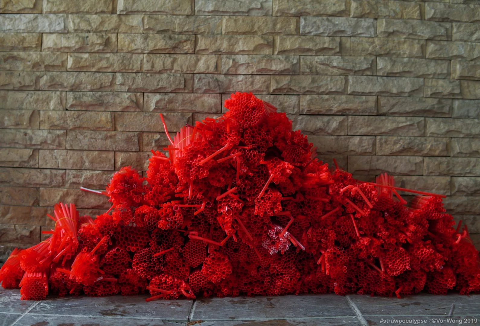 Piles of organized plastic straws during construction of the Strawpocalypse installation
