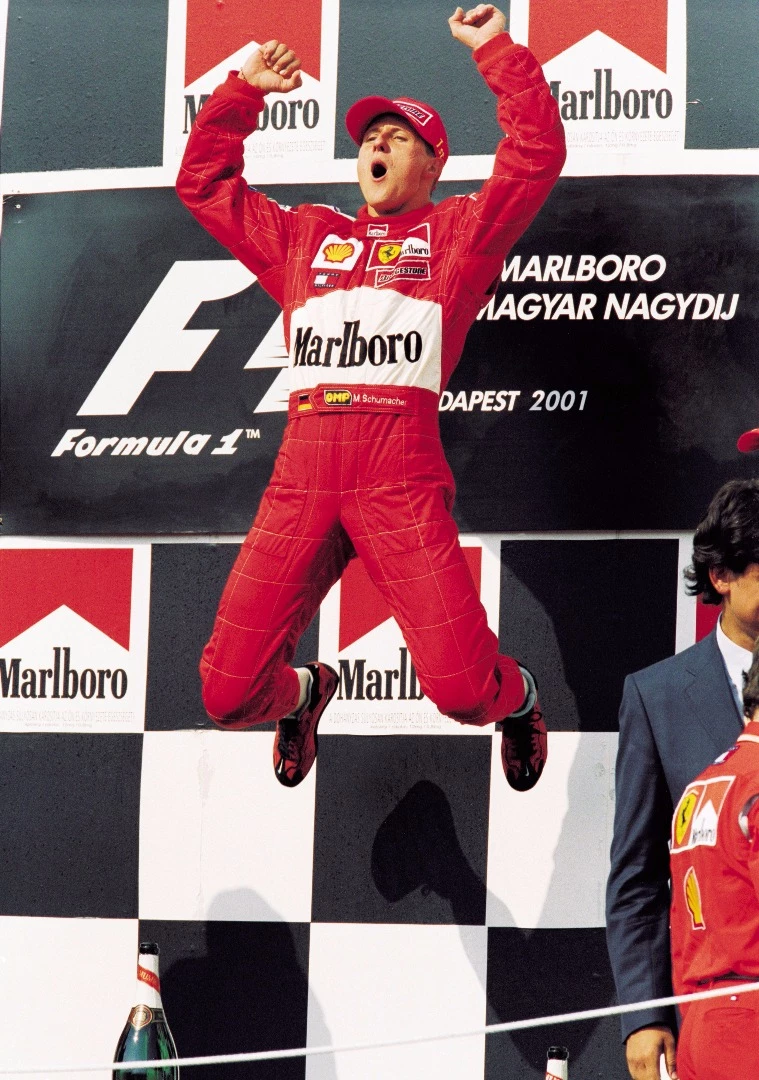 Michael Schumacher celebrates his fourth World F1 Drivers Championship on the podium at the 2001 Hungarian Grand Prix. The win also saw him equal Alain Prost's record of 51 Grand Prix victories.
