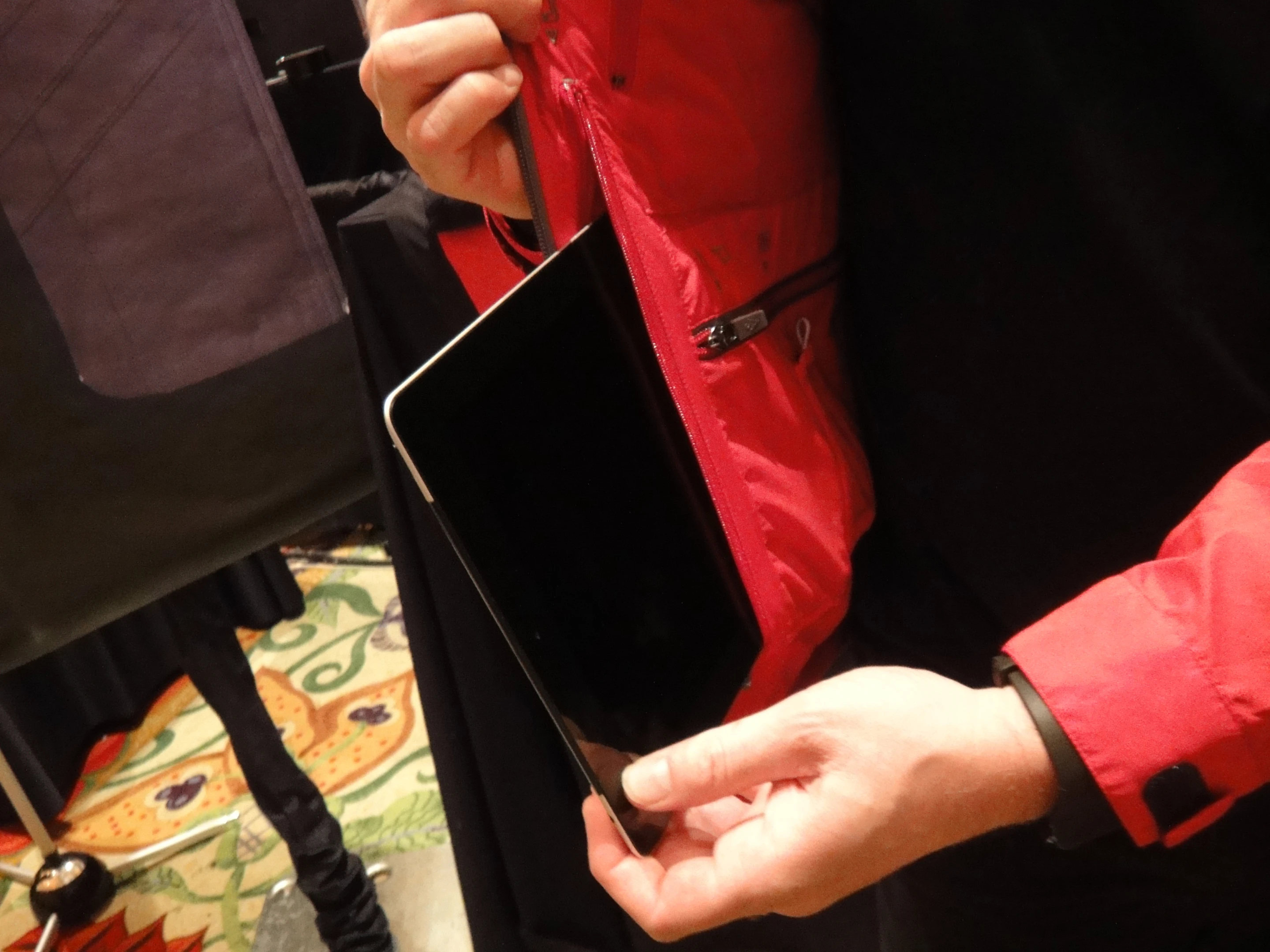 A waterproof iPad pocket is contained within the coat