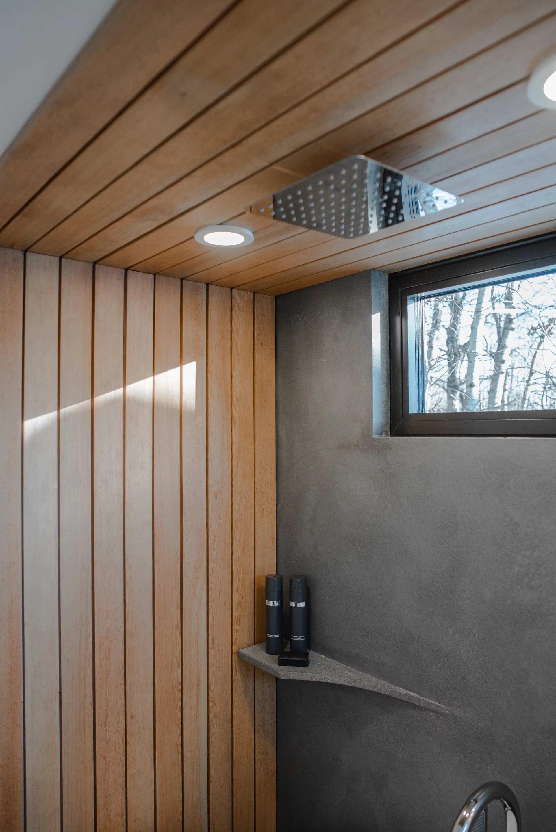 A rain drop shower head is featured in the bathroom