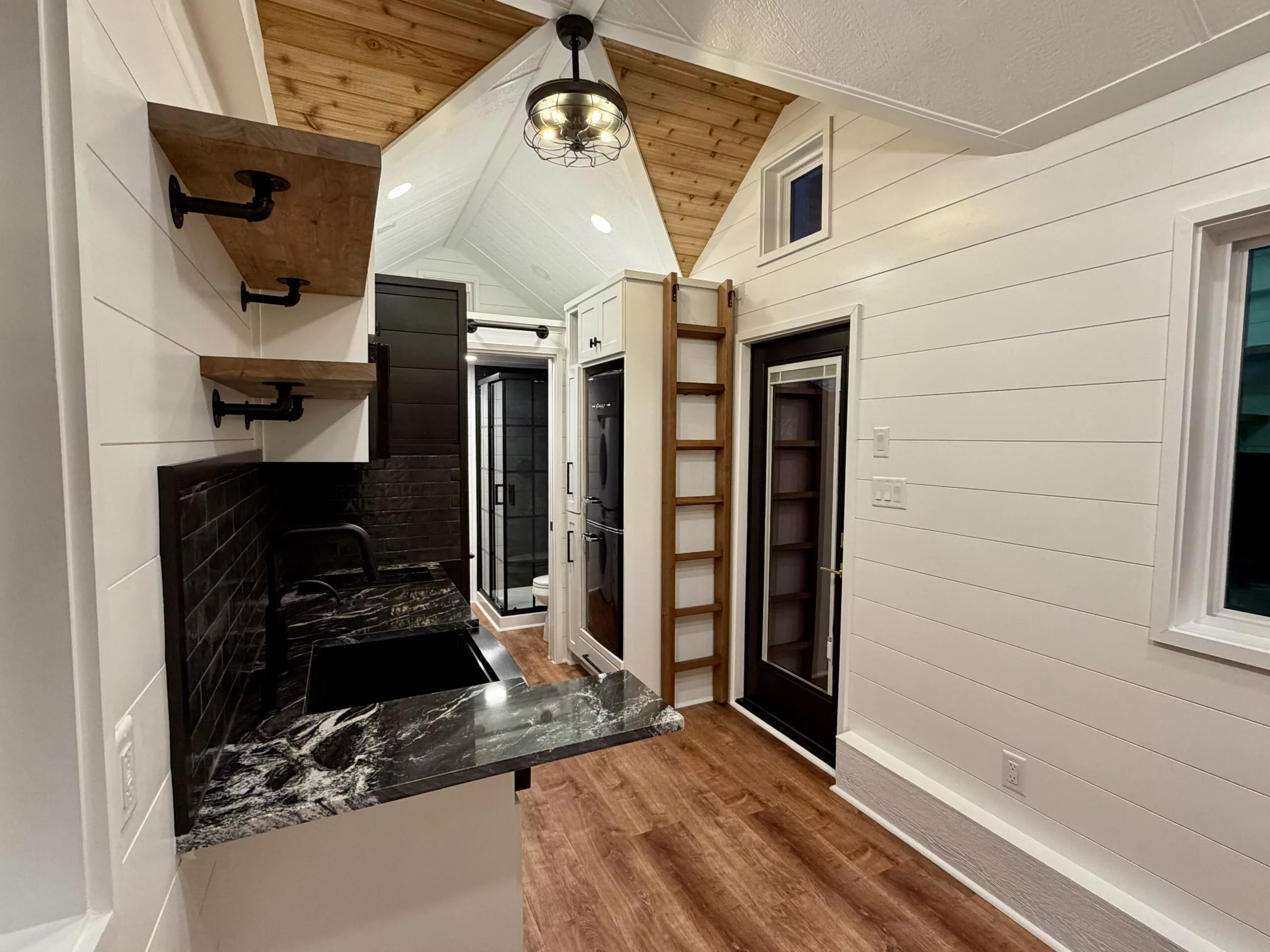 The Betty tiny house's interior is centered around its kitchen area