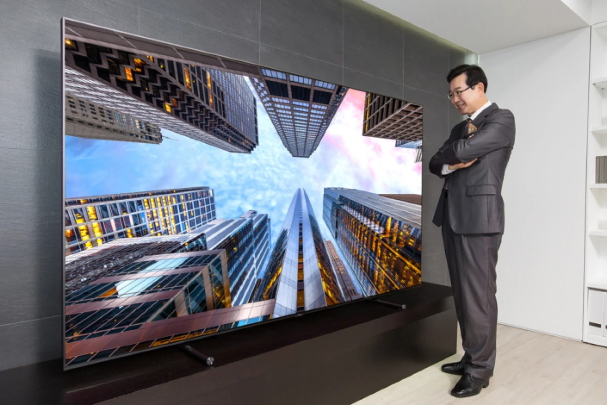 A Samsung executive enjoys the 88-inch QLED TV