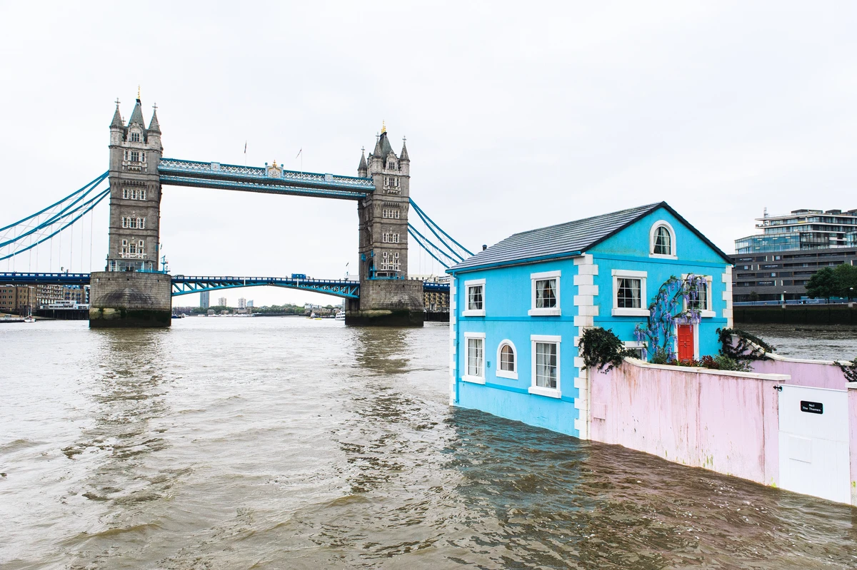 The house walls and garden extend below the waterline, in part to mask the base upon which they are floating
