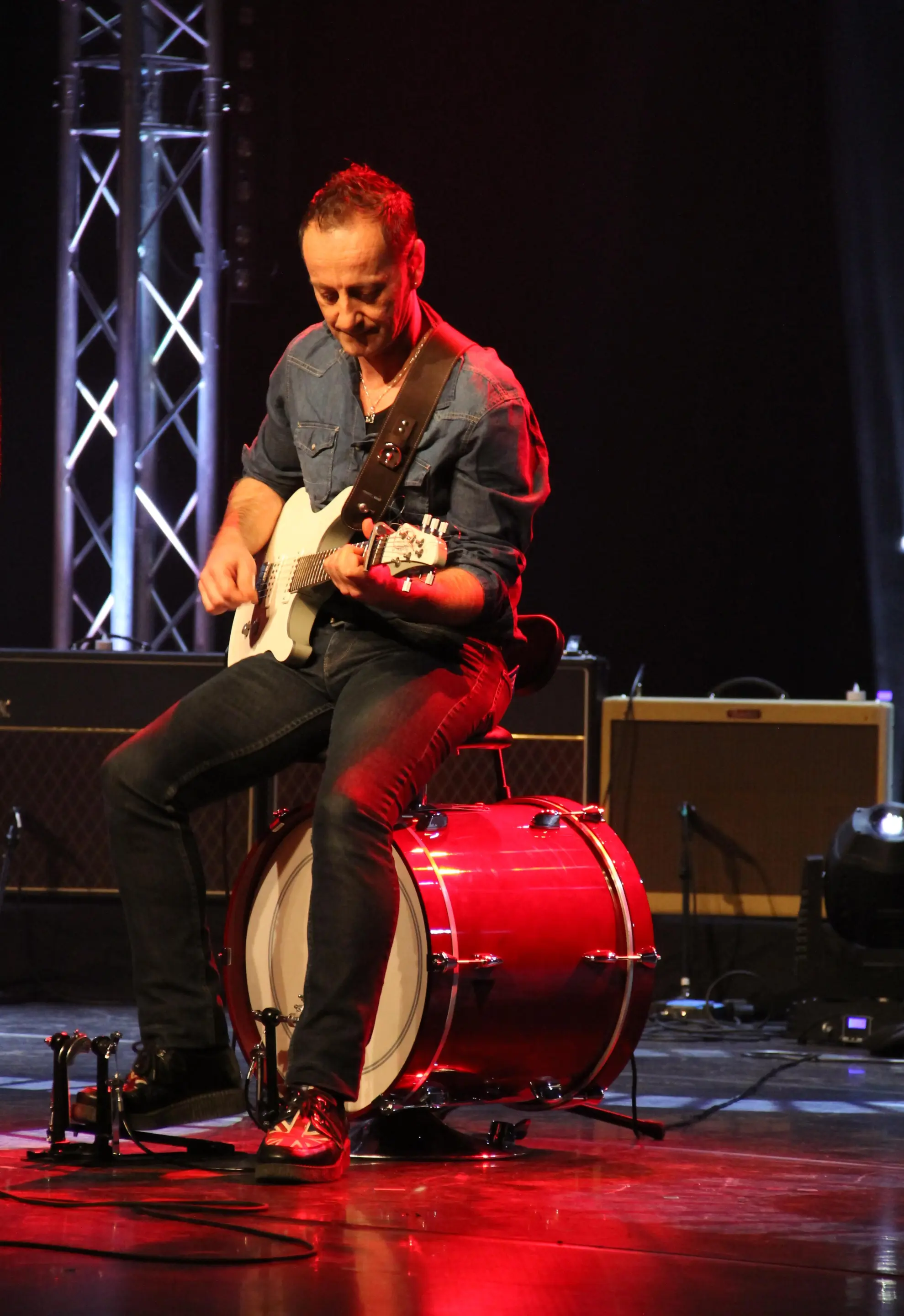 Creator Patrice Bardin playing a Yamaha RGX-A2 guitar while sat on a Drumstooled
