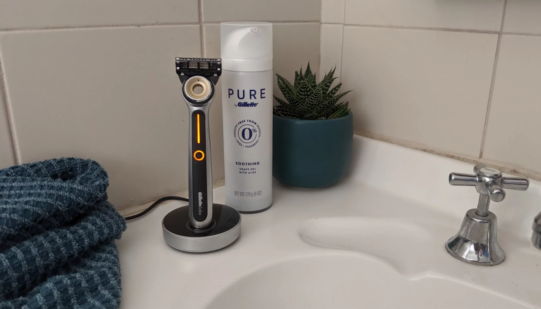The Gillette Labs Heated Razor stands proudly up in its magnetic charger