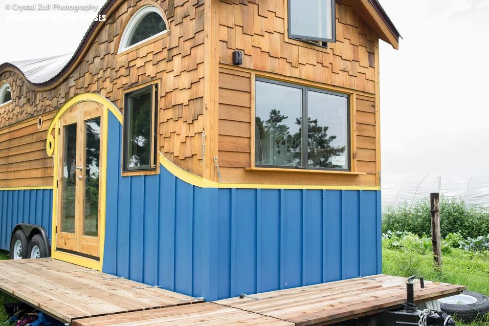 A wraparound fold-down deck surrounds a section of the home