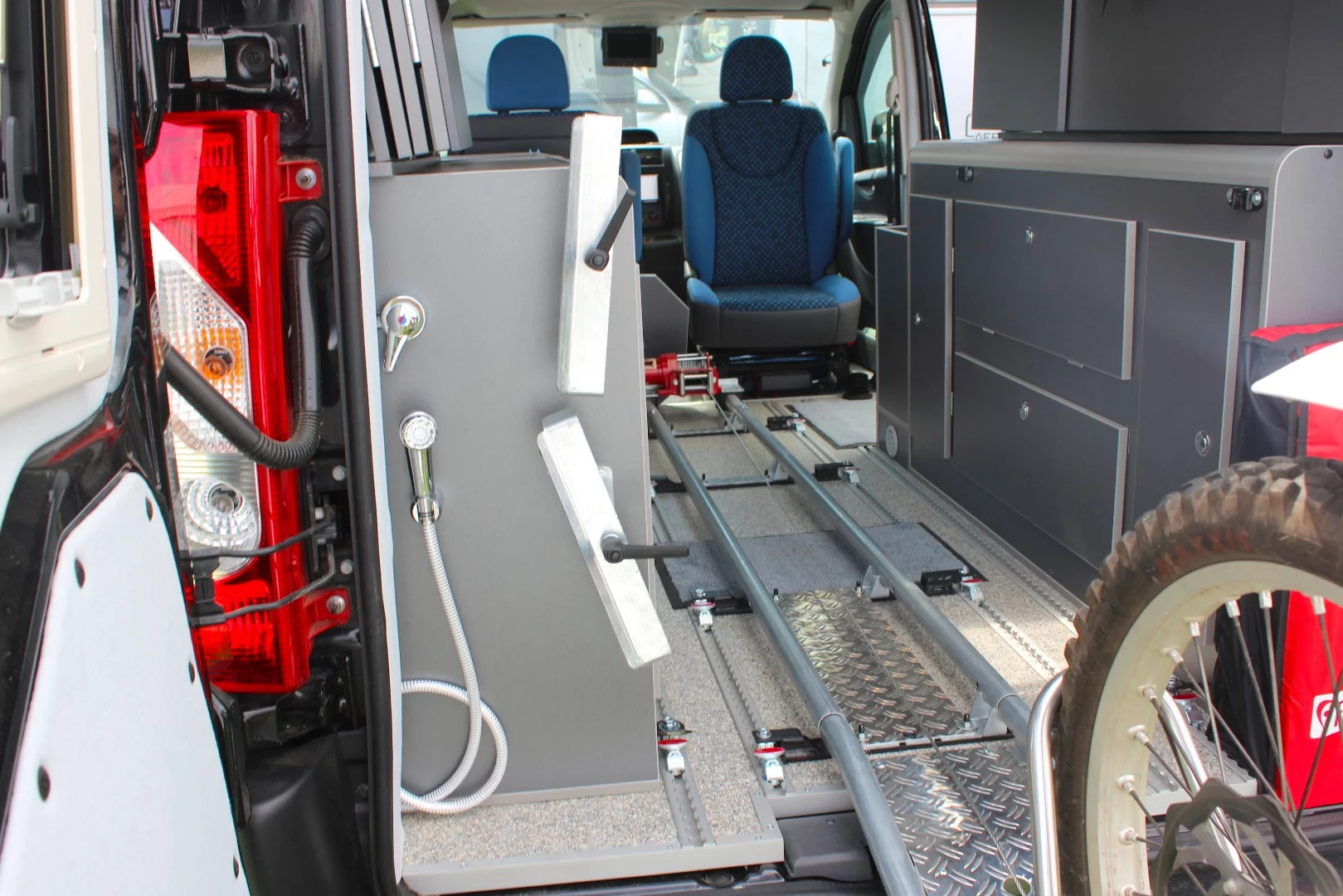 Outdoor shower and motorcycle ramp on Behl-Mobile's special Fiat van