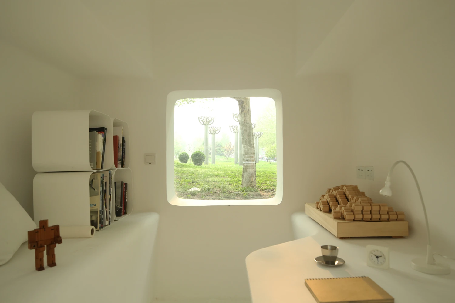 Each modular unit incorporates all interior furnishings into its main architectural structure, including bookshelves, clothes racks, seating and bedding