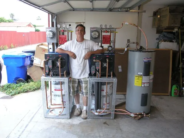 A prototype water heater system that uses cold water to make hot water pictured with Slater's assistant, David Dawson