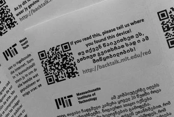 Each laptop in MIT's backtalk project has a sticker explaining the project in the local language