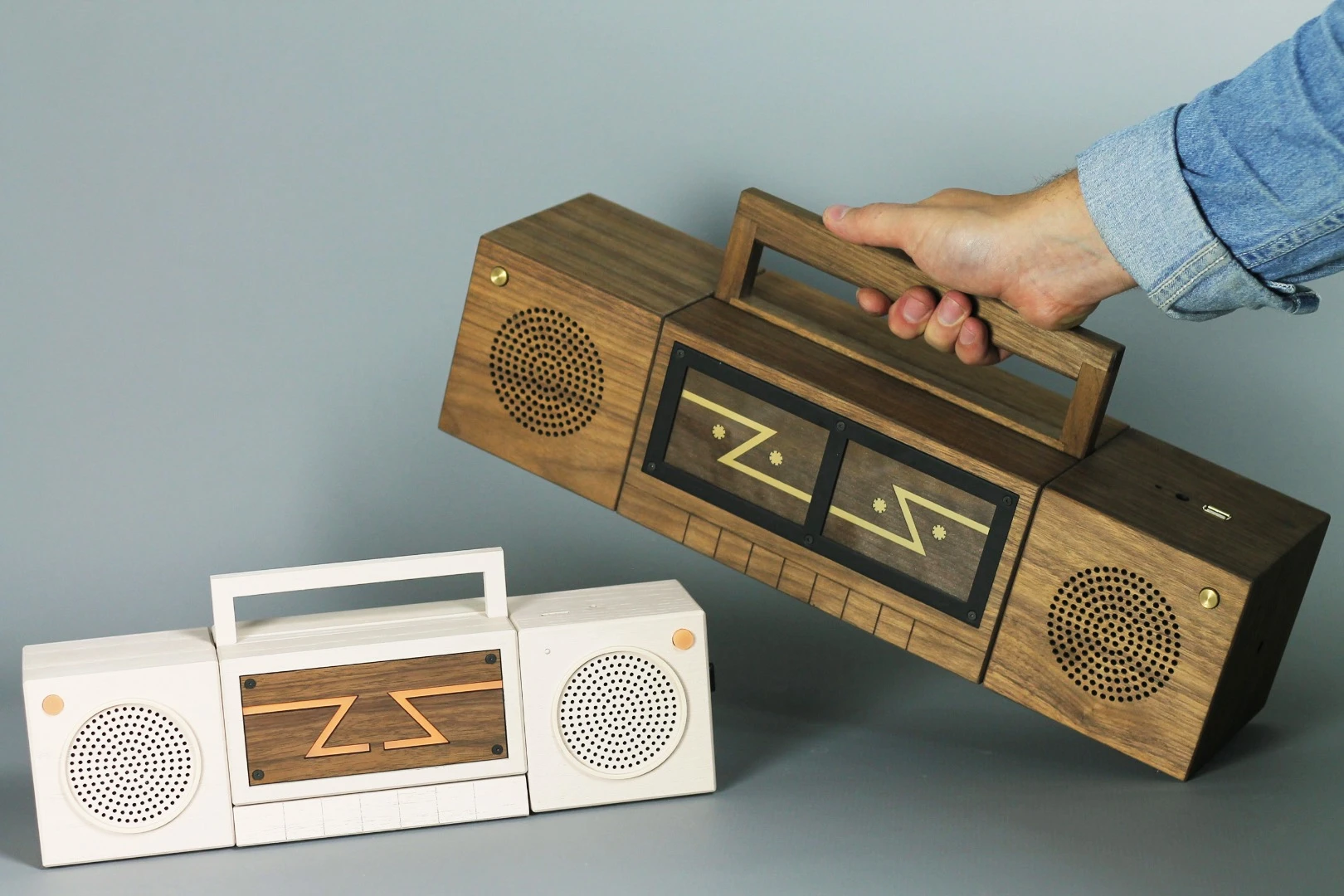 The Zette System is a portable gaming system comprised of several parts that attach together to resemble a 1980s boombox – the middle section contains a projector and two separate controllers
