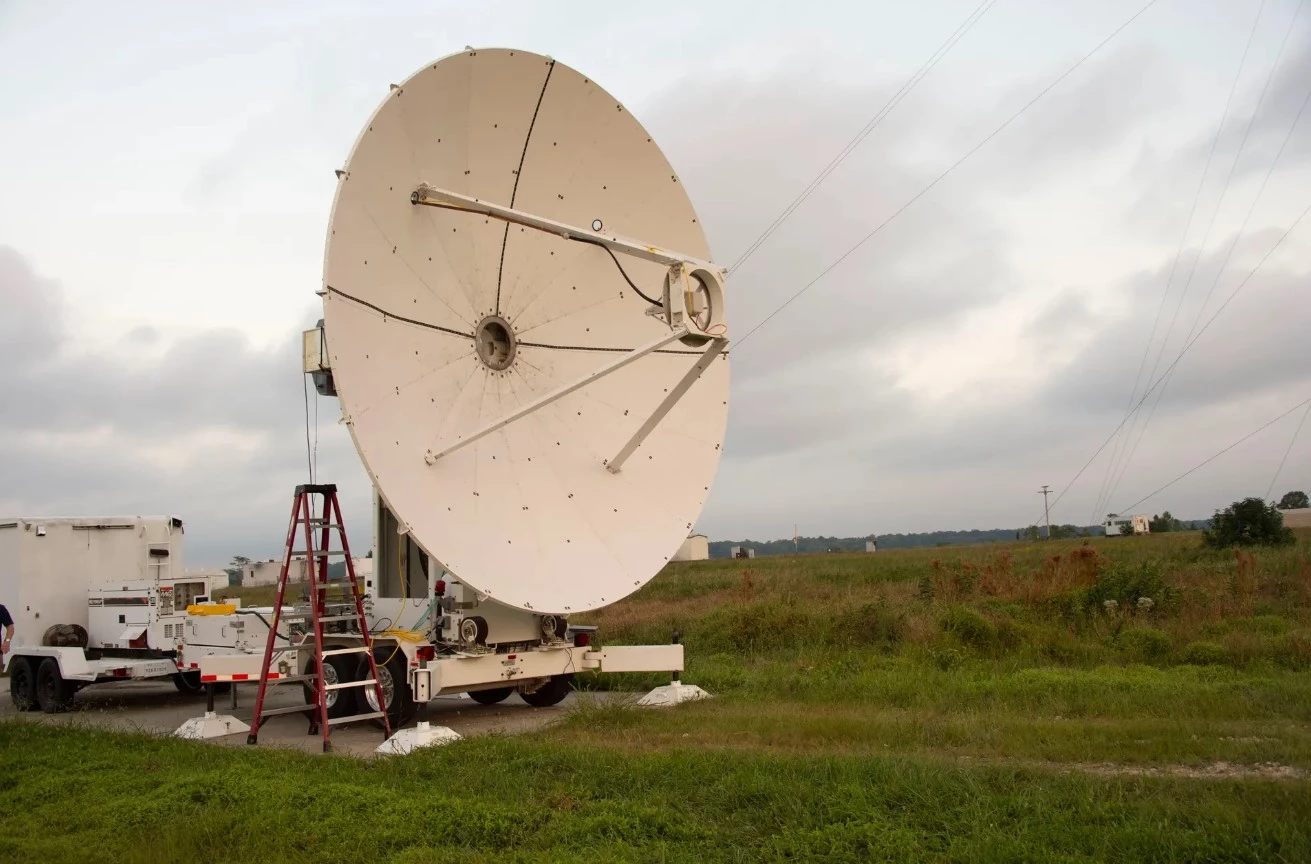 A microwave dish transmitter is pointed toward a rectifying antenna in part of the Safe and Continuous Power Beaming – Microwave (SCOPE-M) demonstration
