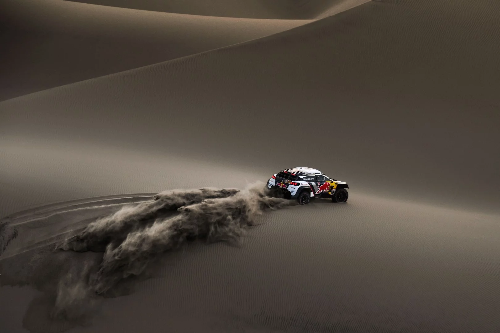 Loeb and Elena's Peugeot carves a fresh path through surreal sand dunes on the 2018 Dakar Rally