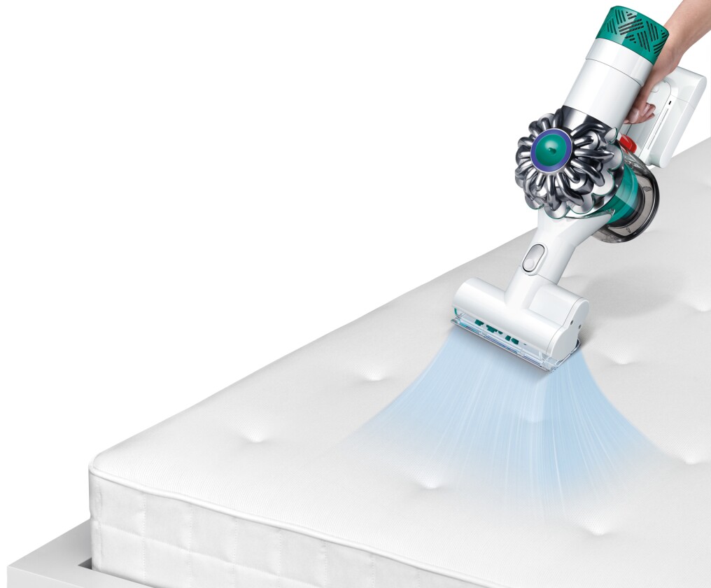 The Dyson V6 Mattress has a motorized brush assembly with powered bar pivots featuring nylon bristles and suction channels for more complete cleaning at the mattress edges