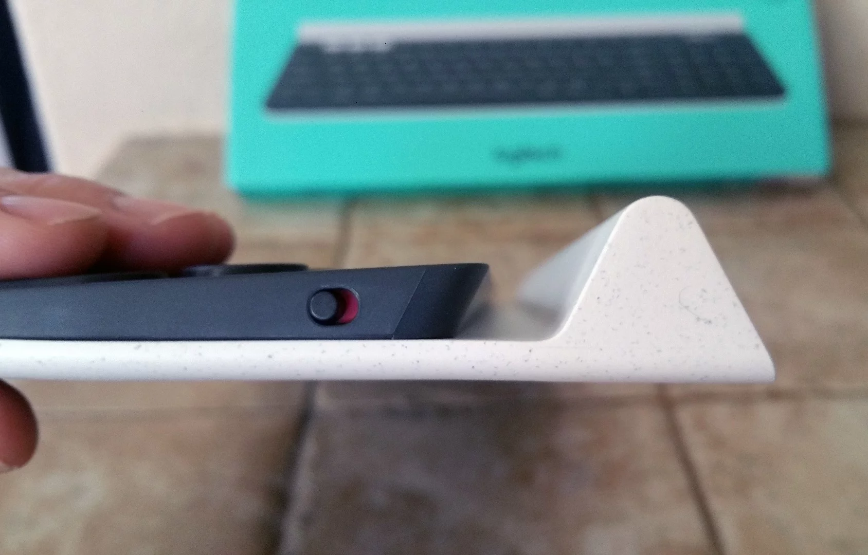 The Logitech K780 multi-device wireless keyboard sports a triangle-shaped ridge behind the top row of keys to cradle mobile devices