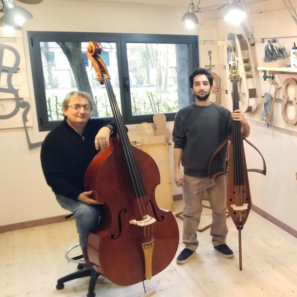 A traditional double bass (left) next to the TravelBass (right)