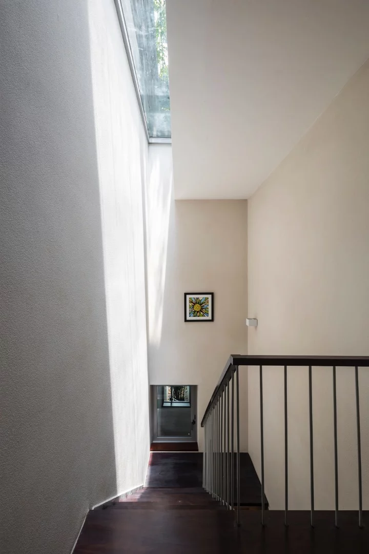 A skylight brightens the stairway in the Breathing House's interior