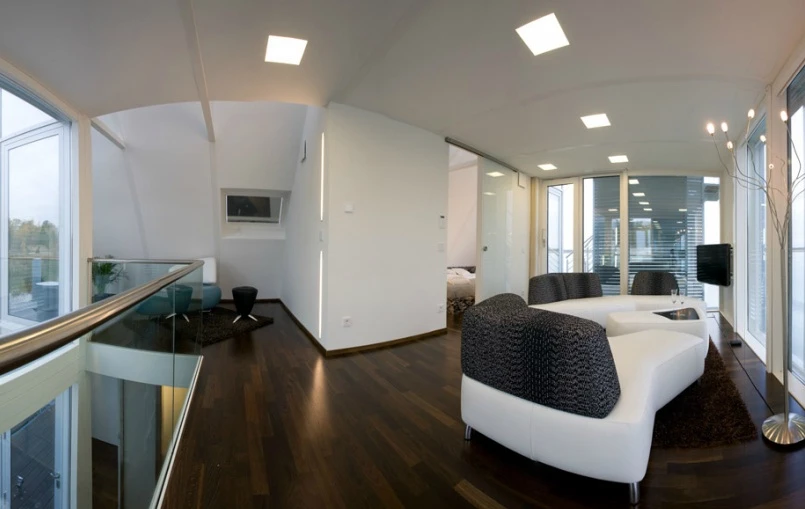 An automated roof-light control system allows natural light to filter through the home