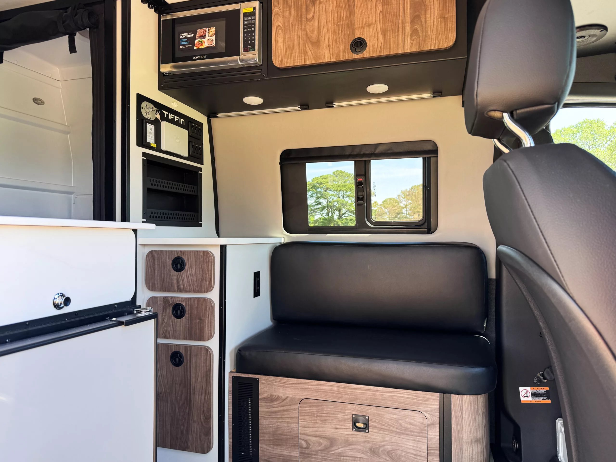 A two-seat side-facing bench, storage console and overhead microwave