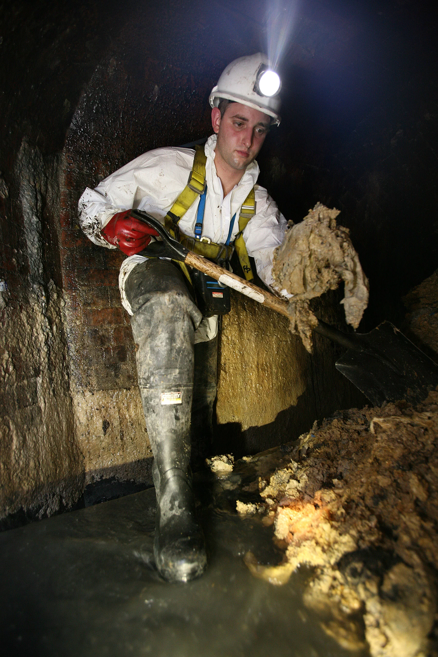 A Thames Water employee clearing fat from beneath London's Leicester Square