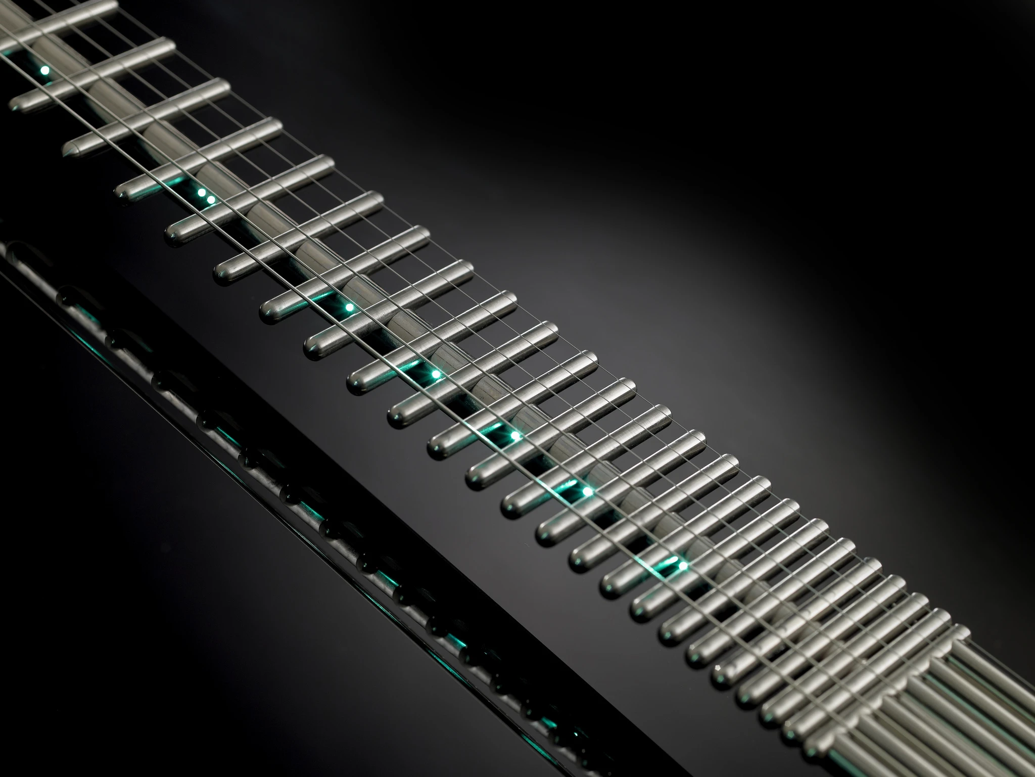 The instrument's fret markers appear in the shape of LEDs that shine through tiny holes along the central channel