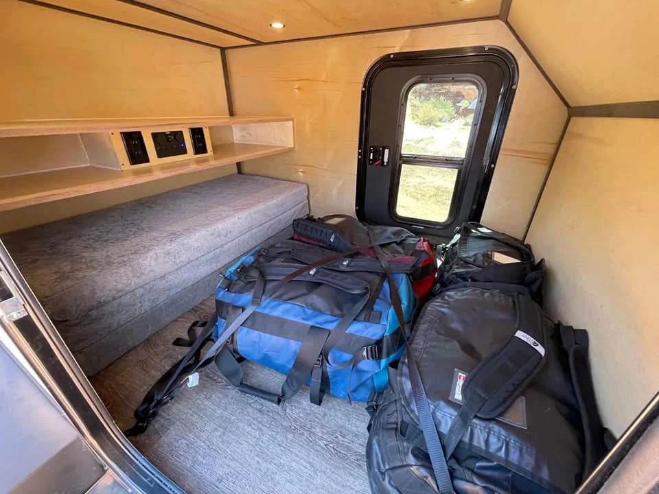 The available tri-fold mattress stores out of the way for gear carry