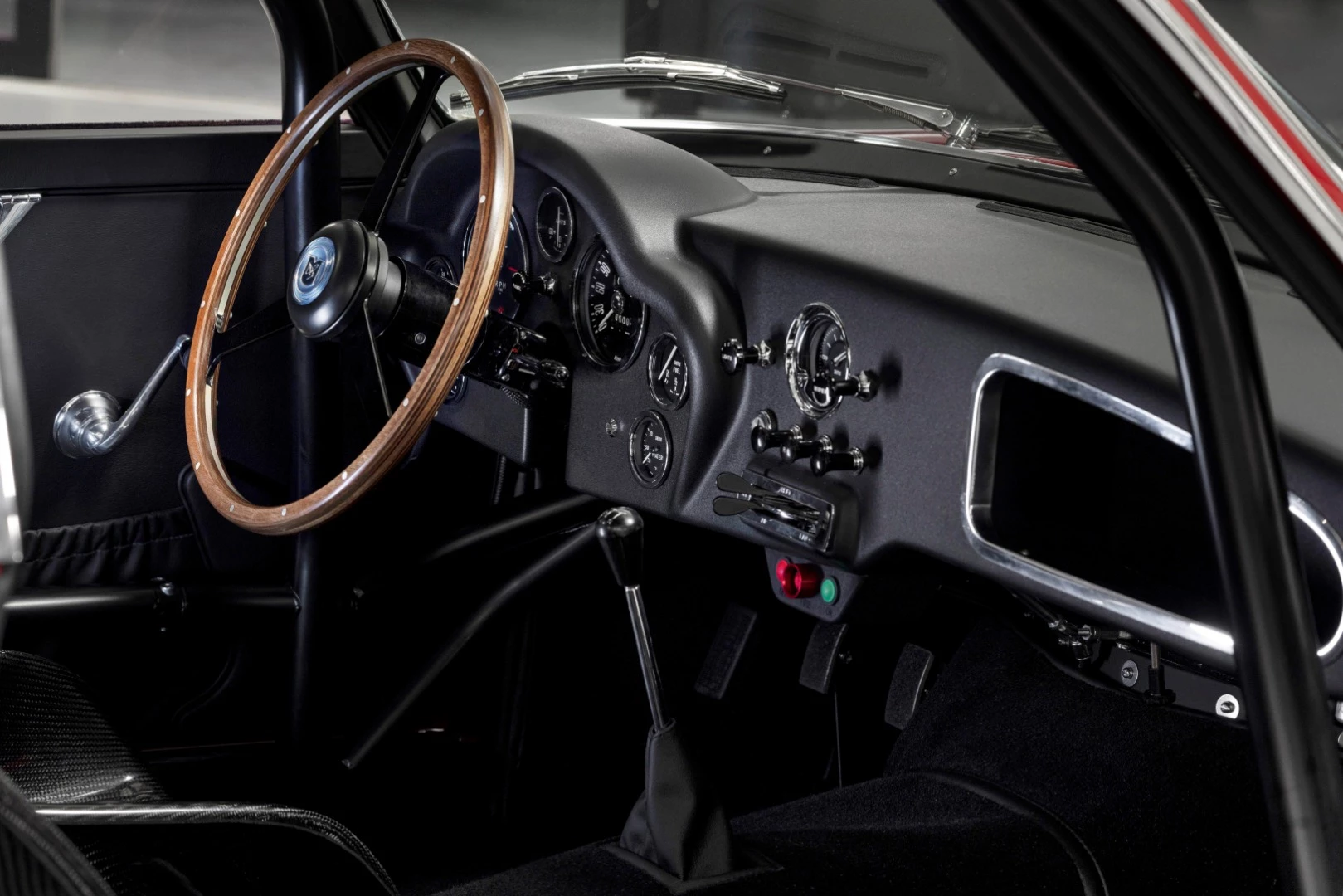 Inside, the Aston Martin DB4 GT Zagato Continuation is trimmed in Obsidian Black leather, which covers the padding in the carbon fiber racing seats, the door cards, headliner and rear cabin. The black Wilton floor carpets are bound in the same black leather trim.
