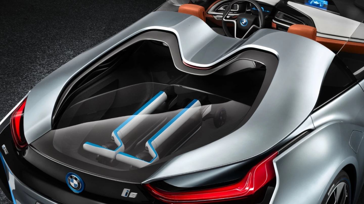 BMW's i8 Spyder with two matching BMW three-wheeled electric kick scooters in the rear